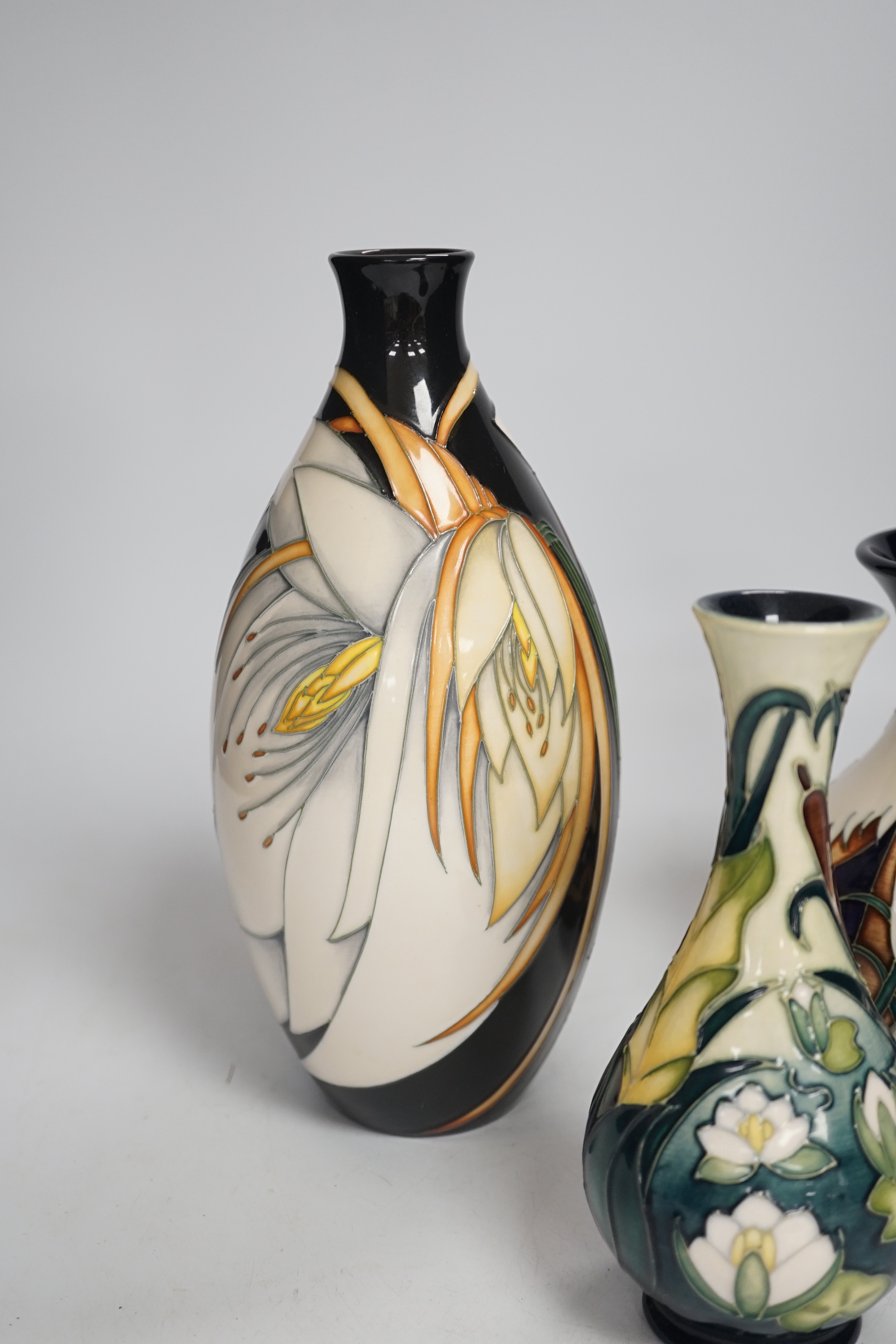 Three Moorcroft vases - a trial vase by Philip Gibson, another trial vase and a ‘Harebell Wood’ limited edition vase by Emma Bossons 2/3, largest 25cm high